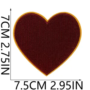 Red heart embroidered patch close-up detail shot showing fine stitching and yellow border.