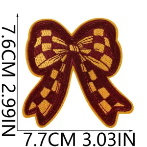 Embroidered bow patch iron-on applique for clothing, jackets, backpacks, and DIY fashion crafts.
