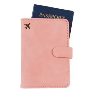 Pink PU leather passport holder with gold airplane decoration and passport slot for travel.