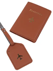 Brown leather passport holder and luggage tag set with gold airplane travel accessories.