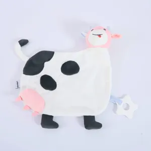 Plush cow baby security blanket detail showing cute cartoon animal head, teether and soft fabric.