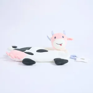 Close-up detail of the cute cow plush comfort blanket with safe teether toy for newborn babies.