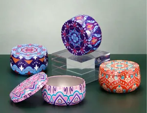 Detailed close-up of decorative metal tin cans with vibrant mandala patterns for storage.
