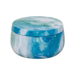 Detailed view of the blue marble pattern round metal tin jar, compact storage design.