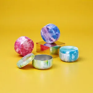 Metal tin jars with colorful marble galaxy print, perfect for tea, candy, or scented candles.