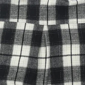 Men's flannel plaid shirt detail texture close-up, classic black and white style design.