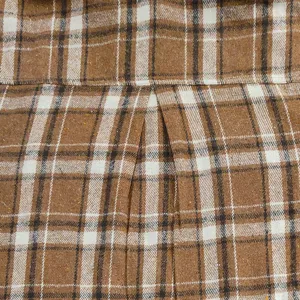 Detailed close up view of men's brown plaid flannel shirt showing back pleat fabric.