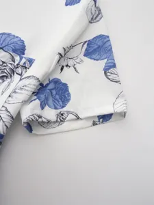 Blue and white rose floral print shirt fabric detail close-up view showcasing soft texture.