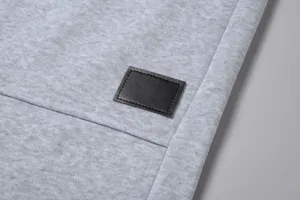 Vista dettagliata del tessuto dei pantaloni felpati da uomo con etichetta in pelle.