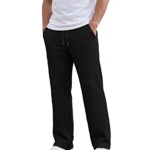 Dettaglio pantaloni casual in tessuto waffle nero, coulisse in vita, vestibilità dritta.