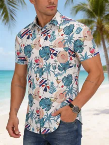 Detailed view of the tropical hawaiian print short sleeve shirt with palm trees and cocktail.