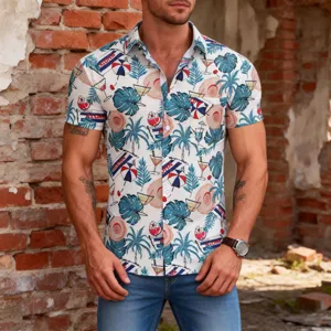 Detailed shot of men's tropical Hawaiian print short-sleeve shirt with palm and cocktail motifs.