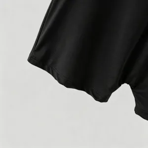 Detail shot of black stretch knit fabric and neat sleeve stitching for men's fashion bodysuit.