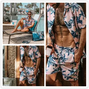 Detail view of men's tropical palm tree print short sleeve shirt and shorts set summer beach.