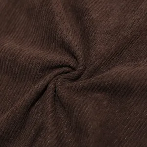 Close-up view of premium brown corduroy fabric texture showing soft ribbing and natural folds.