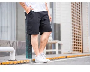Casual black five-point shorts detail shot, comfortable loose fit, ideal for summer daily wear.