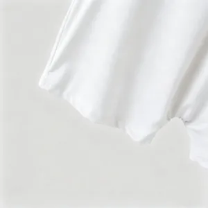 White knit bodysuit detail showing soft fabric texture and fine stitching for men.