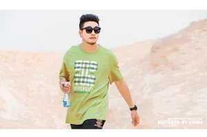 Detailed view of the casual green short sleeve mens t shirt with Boston University graphic print.