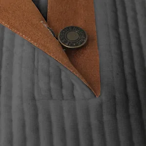 Close-up detail of men jacket fabric with ribbed texture and metal button decoration.