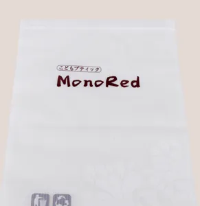 MonoRed frosted plastic towel packaging bag detail, size 26.5x18cm, translucent stripe design.