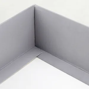 Grey gift box inner corner detail, sturdy cardboard packaging component for gift sets.
