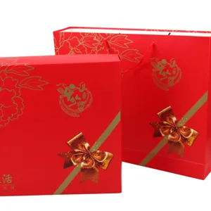 Red gift box detail view, gold floral print design, festive packaging set for wedding celebrations.