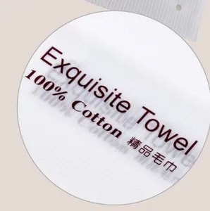 Detail view of the cotton towel packaging label, showing 100% cotton material and text.
