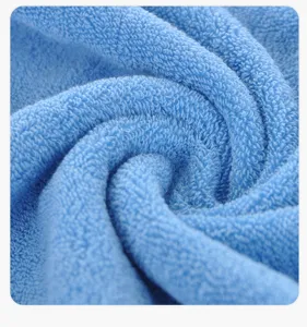Detailed close-up view of soft blue cotton face towel showcasing fine texture and loop weave.