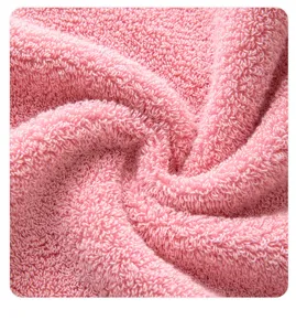 Pink cotton towel fabric close up texture, soft loop detail for bath towel set display.