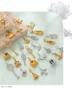 Detailed view of various vintage 18K gold plated jewelry charms including airplane and keys