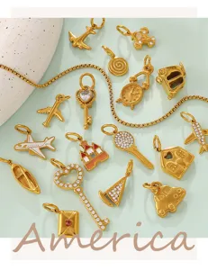 Detail view of 18K gold plated vintage charms featuring airplane and heart key shapes