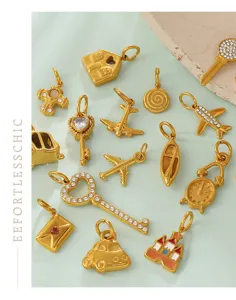 Detail view of various vintage 18K gold plated charms with sparkling rhinestones
