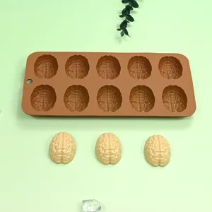 Detailed view of brain-shaped silicone mold with finished yellow chocolate brains