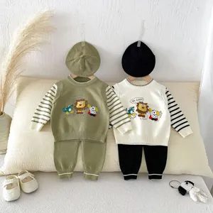 Detailed view of baby knit sweater vest set with cute cartoon embroidery and stripes.