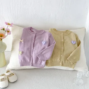Infant baby knitted cardigan sweater with cute heart and bow detail, soft autumn outerwear.