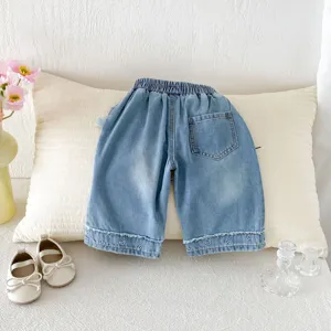 Detailed view of trendy toddler girls wide-leg denim pants featuring cute heart embroidery.