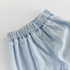 Kids denim pants waist detail shot, light blue casual summer children clothing closeup.