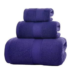 Set of three purple cotton towels, soft, absorbent, and comfortable for home use.