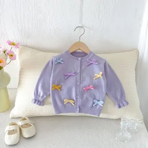 Baby girl sweet knit cardigan with cute colorful bows, stylish autumn toddler sweater top.