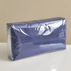 Solid color cotton towel set packed in transparent film, displayed neatly for home use.