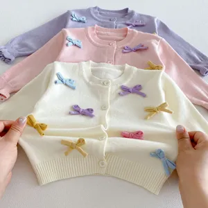 Cute baby girls knitted cardigan sweater with sweet colorful bows and buttons for autumn.