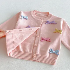 Cute baby girl pink knitted cardigan featuring colorful bows, button closure, and soft texture.