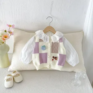 Detail view of infant knit vest set with sweet lace collar, colorful patch and strawberry embroidery.