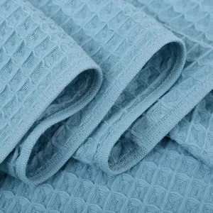 Pure cotton waffle weave bath towel in light blue, folded texture detail main view