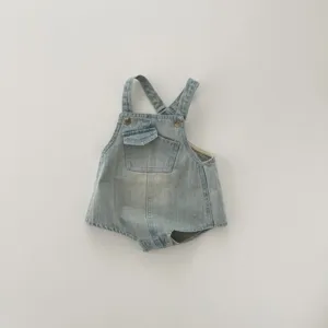 Infant denim romper detail showing classic bib, small front pocket and metal buttons design.