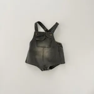 Detailed view of the vintage washed denim baby romper with cross straps and a cute pocket.