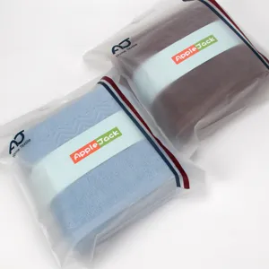 Soft pure cotton bath towels set in elegant gift packaging with brand label design.