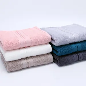 Plain 100% cotton soft bath towels set, stack of multi-color hotel quality absorbent towels.