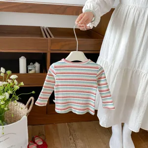 Infant striped knit top detail view, soft cotton long sleeve baby pullover shirt for autumn.