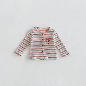 Baby girl knit cardigan detail, colorful stripe pattern, cute bow embroidery, cozy material.